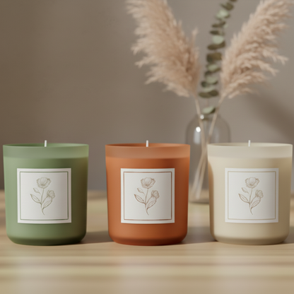 Green candle with a label on a wooden surface and blurred background