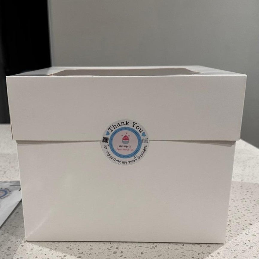 White box with a 'Thank You' label on a gray surface