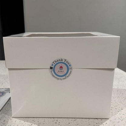 White box with a 'Thank You' label on a gray surface