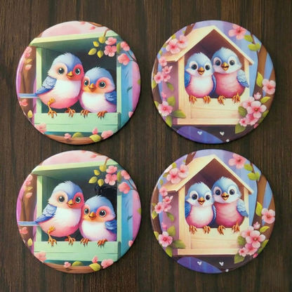 Four colorful coasters with cartoon birds and a birdhouse on a wooden surface.