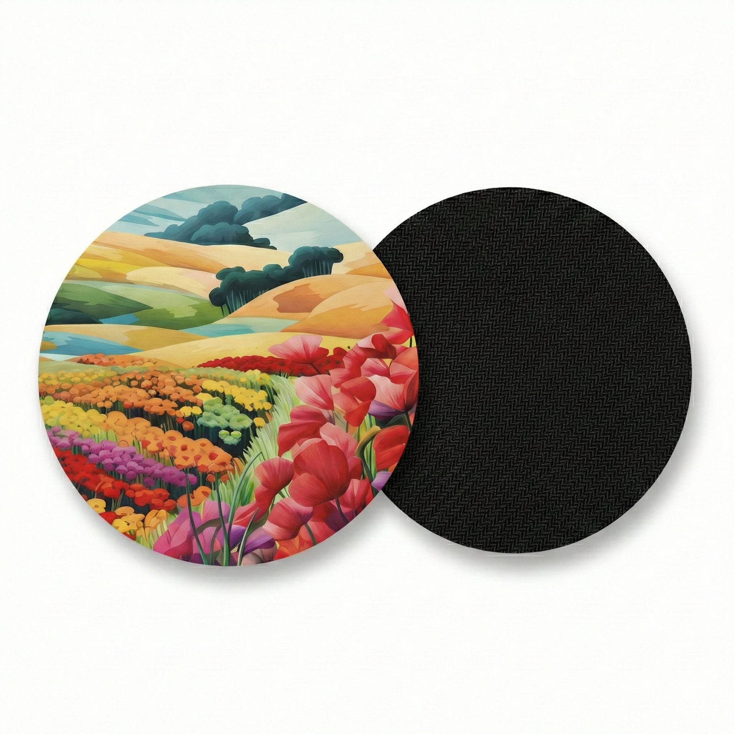 Round coaster with colorful landscape design on one side and black rubber back on the other, on a white background.