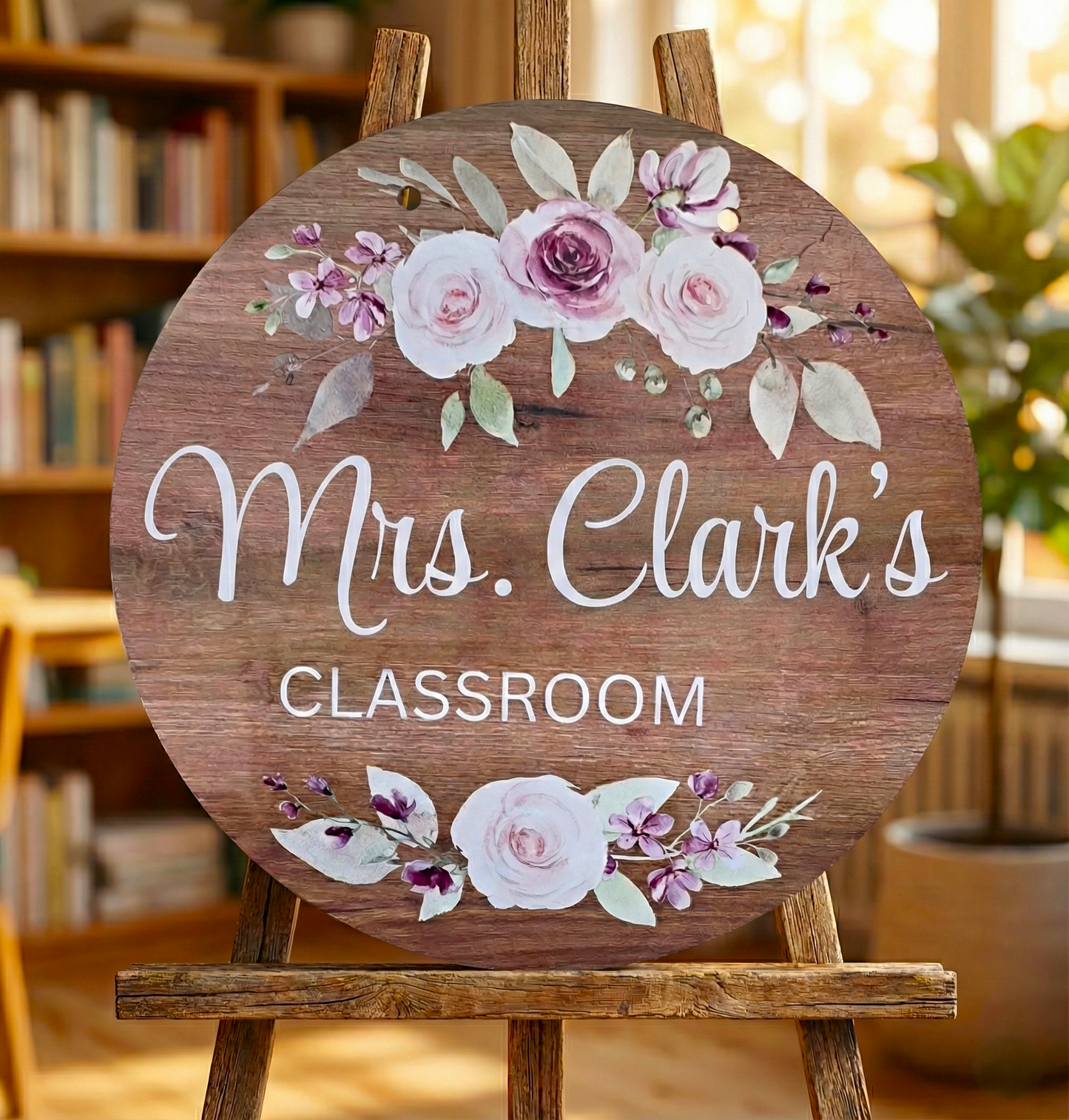 Wooden sign with floral design and 'Mrs. Clark's Classroom' text on an easel.