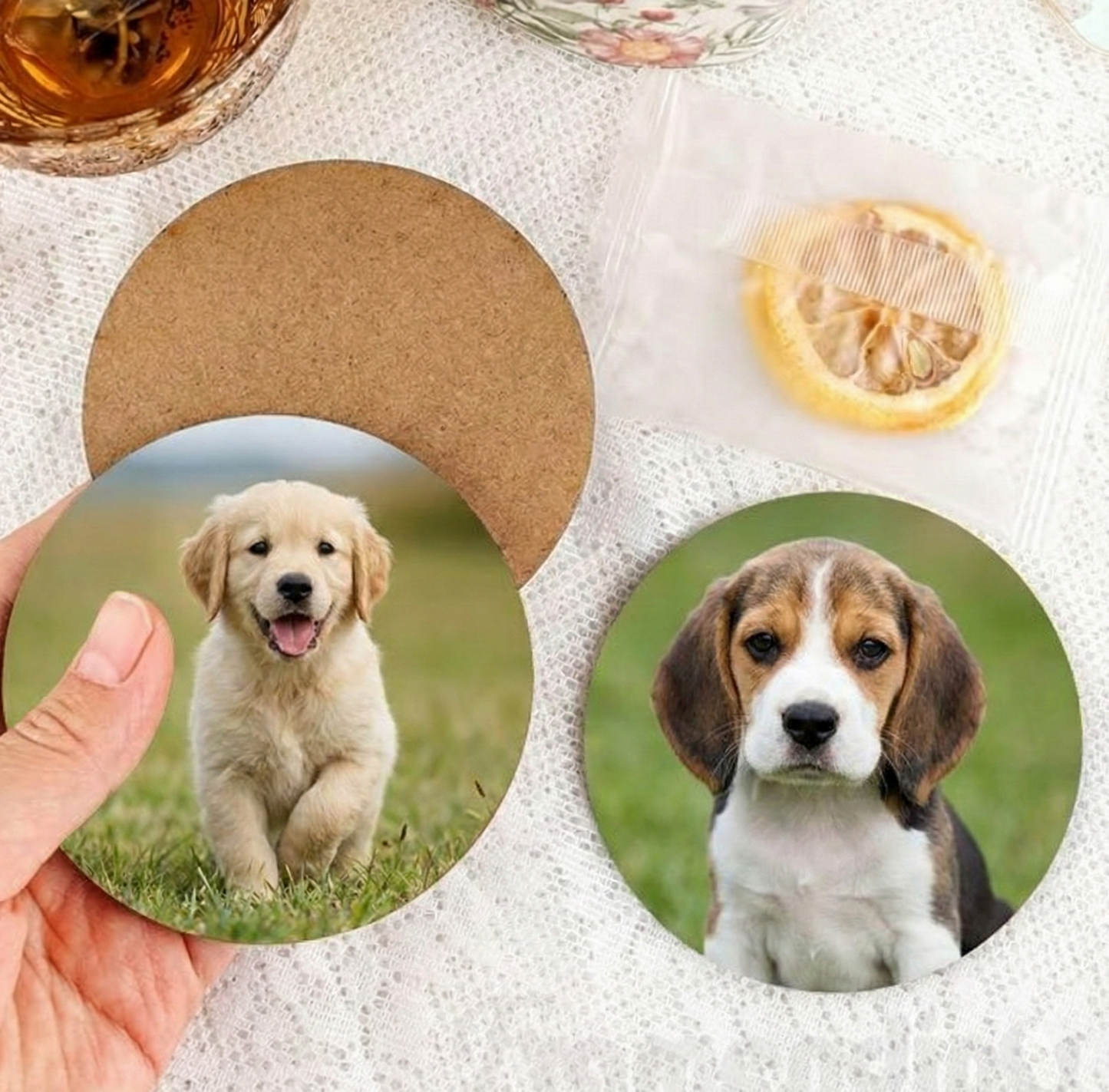 Two circular coasters with images of puppies on a textured surface.