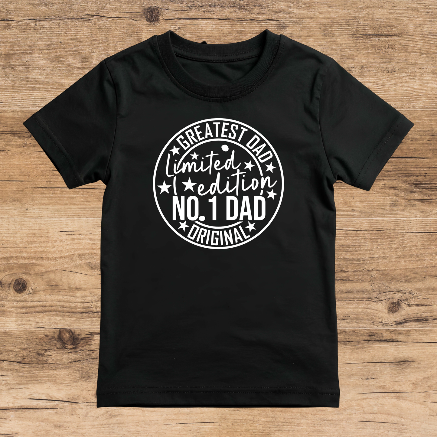 Black t-shirt with white text on a wooden surface
