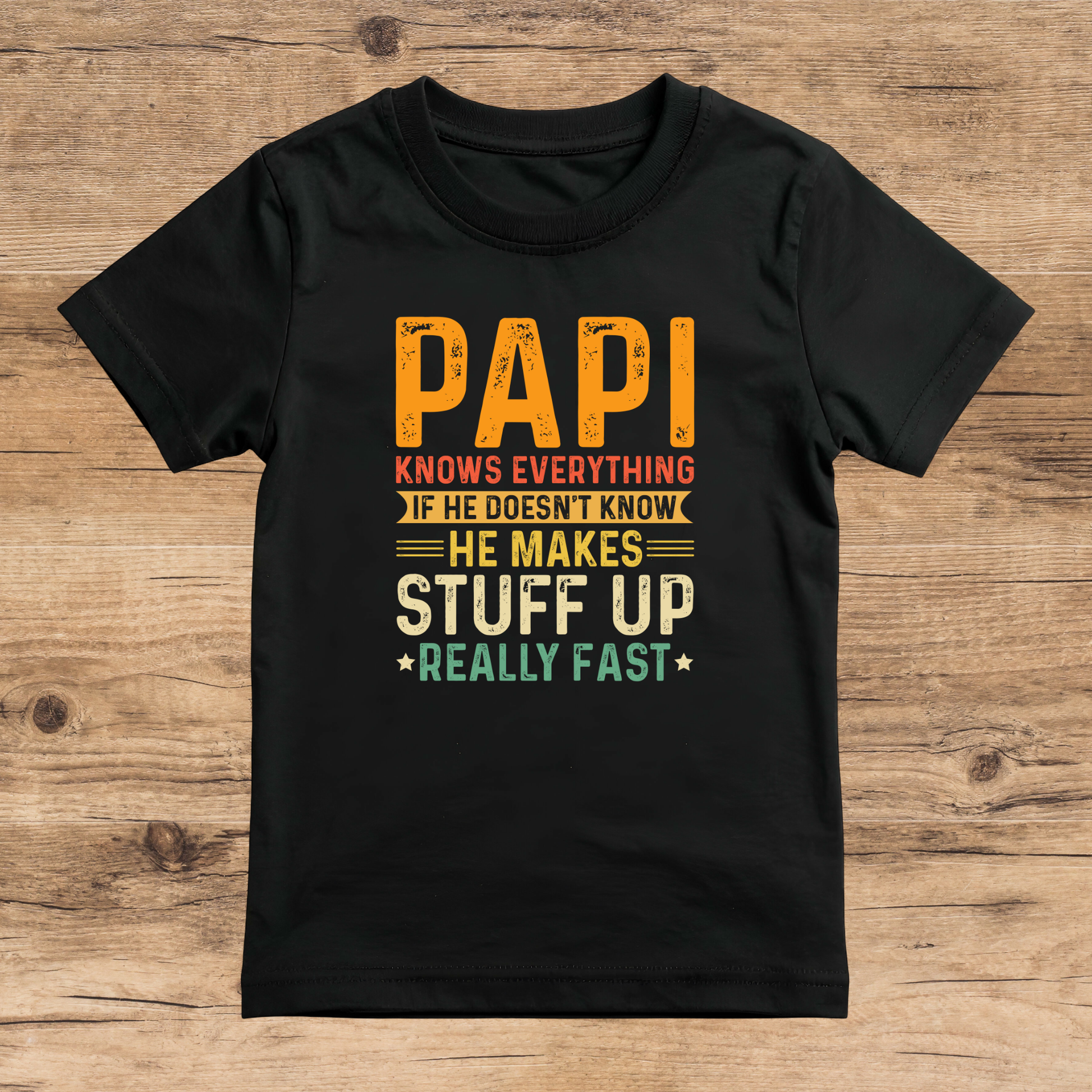 Black t-shirt with colorful text on a wooden surface