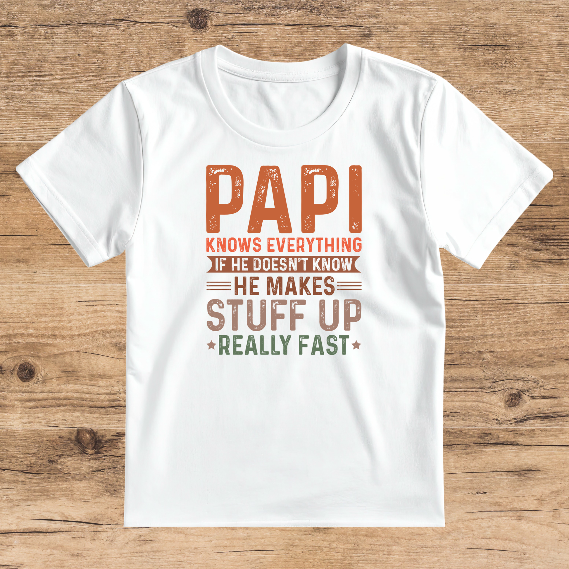 White t-shirt with humorous text design on a wooden surface
