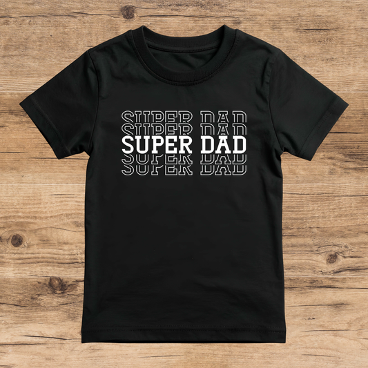 Black t-shirt with 'Super Dad' text on a wooden surface