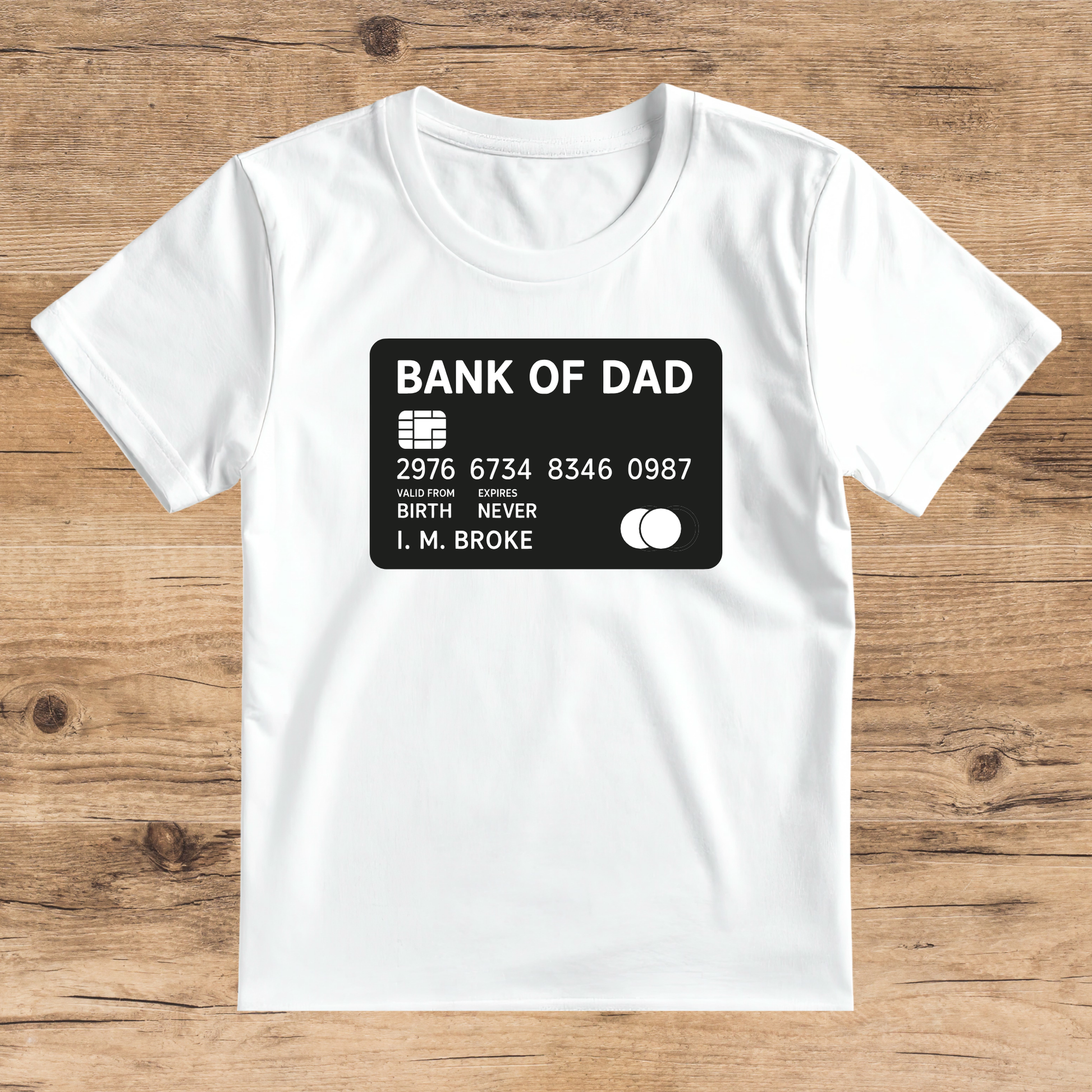 White t-shirt with a graphic of a bank card design on a wooden surface