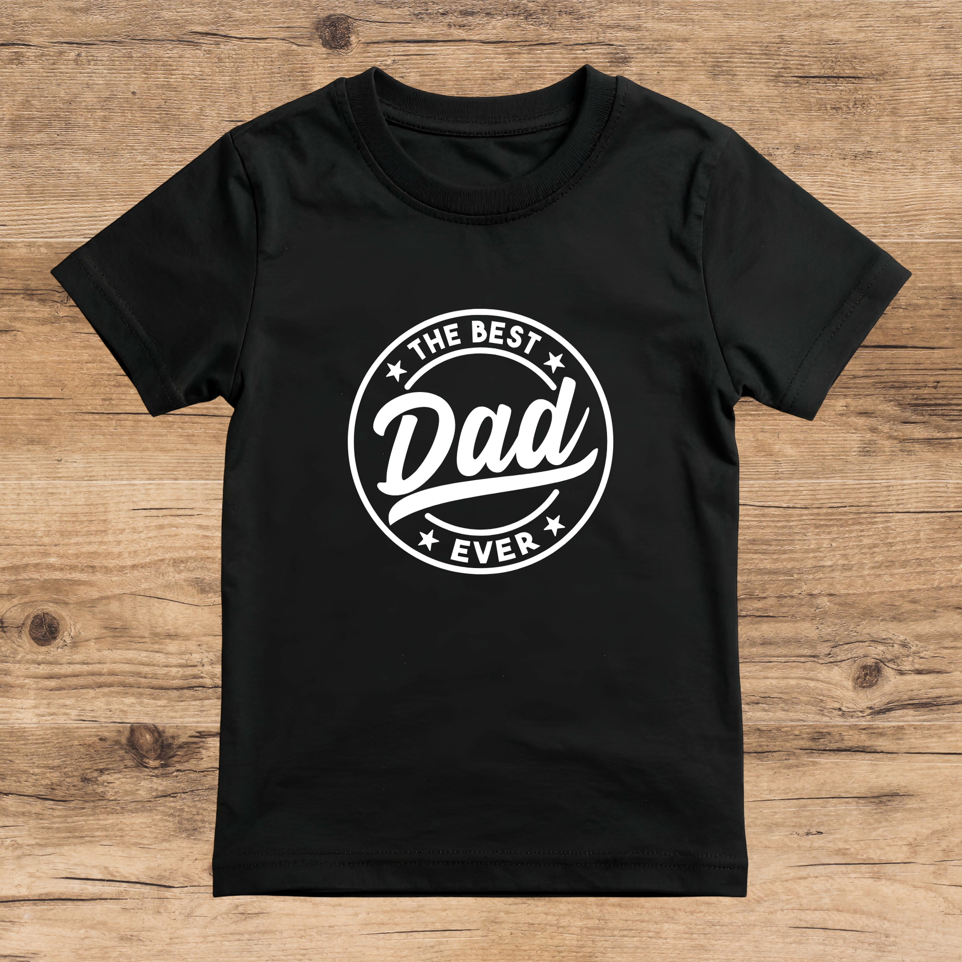 Black t-shirt with 'The Best Dad Ever' text on a wooden surface