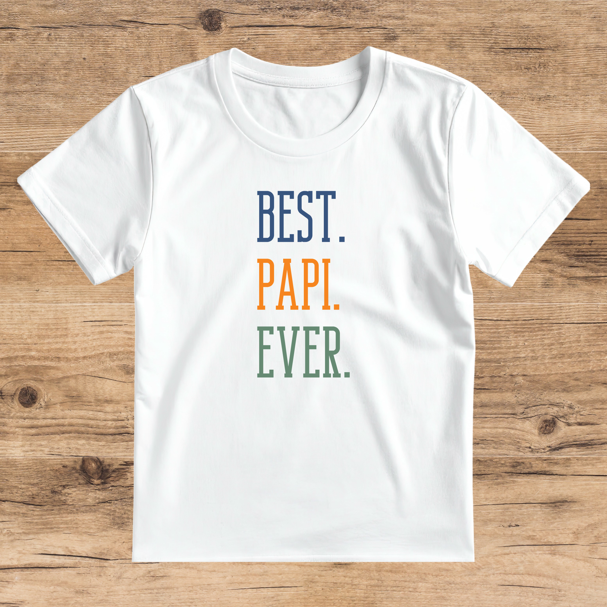White t-shirt with 'BEST. PAPI. EVER.' text on a wooden surface