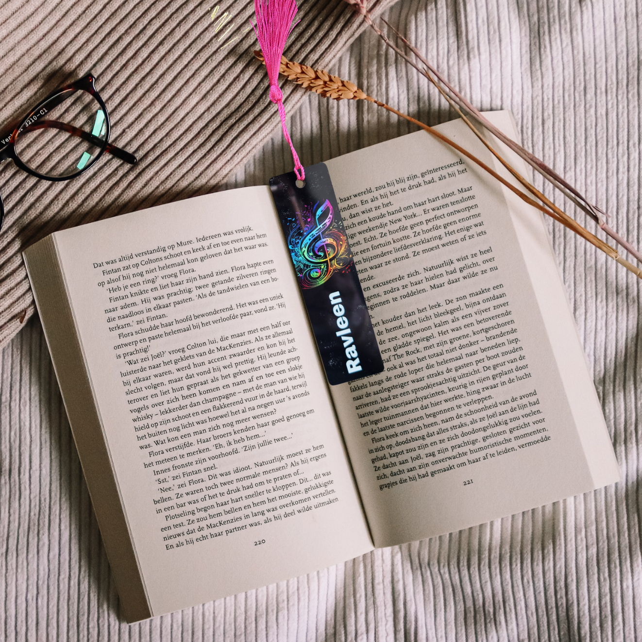 Open book with a colorful bookmark and tassel on a textured surface