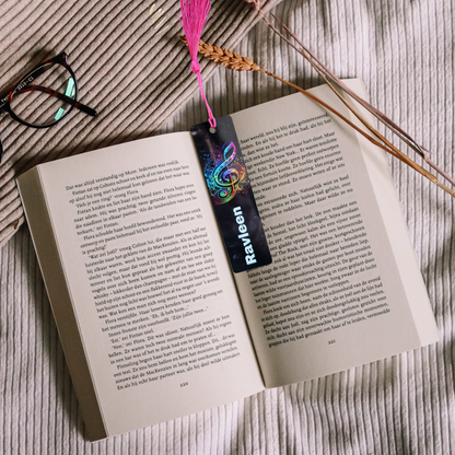 Open book with a colorful bookmark and tassel on a textured surface