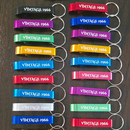 Set of colorful 'Vintage 1966' keychains on a dark surface