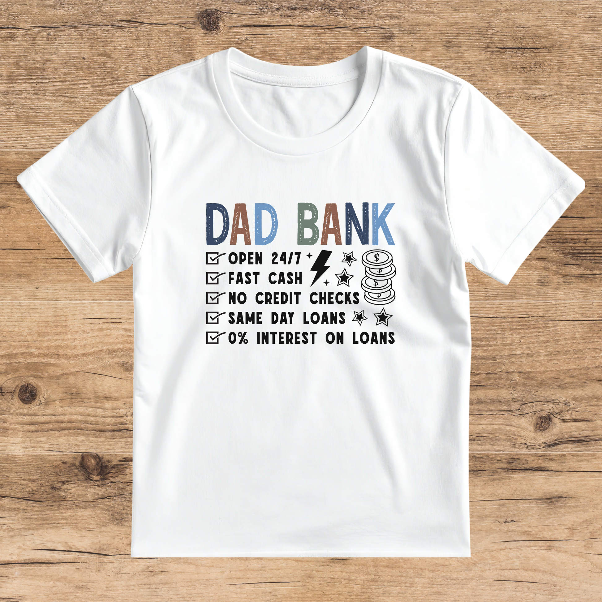 White t-shirt with 'Dad Bank' graphic on a wooden surface