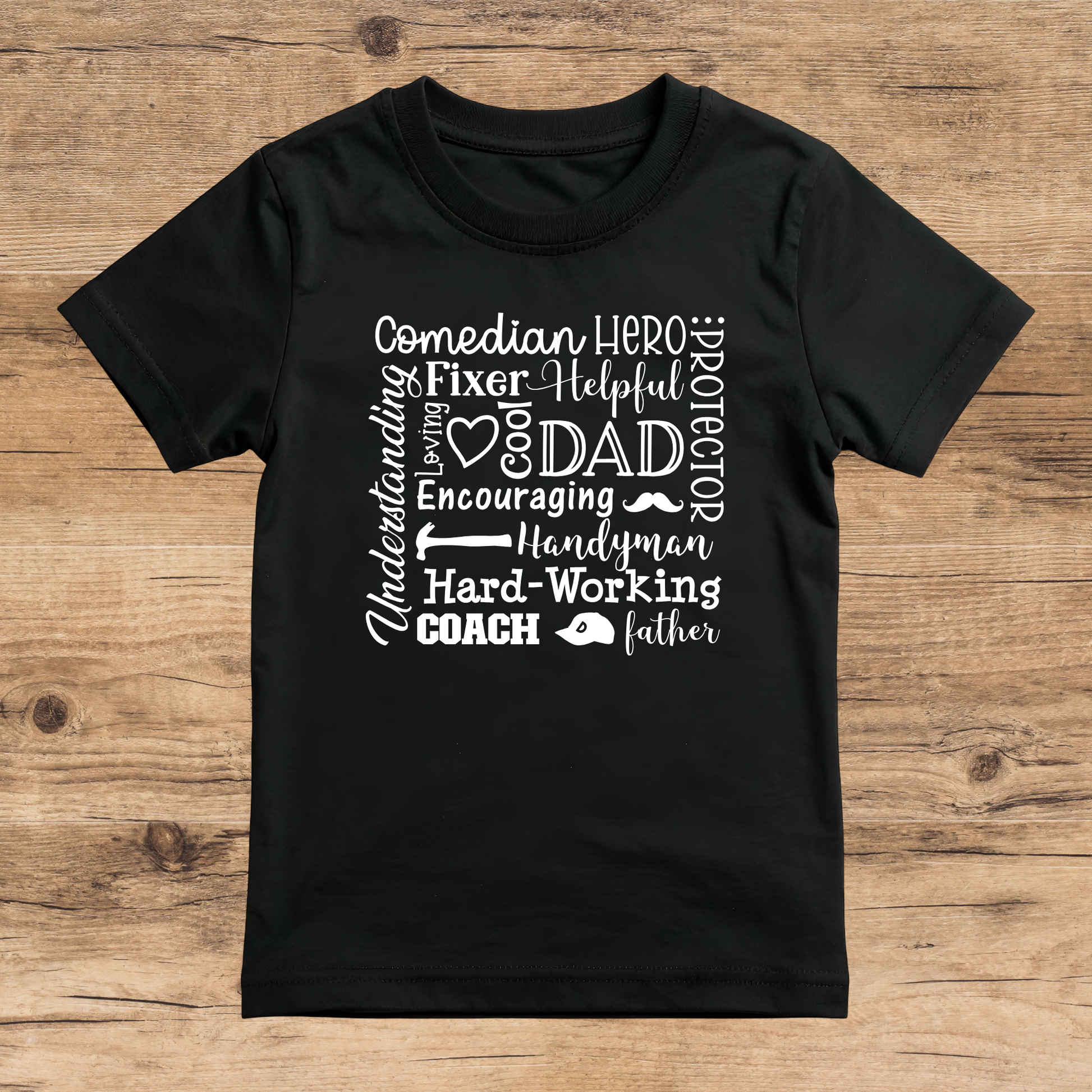 Black t-shirt with white text on a wooden surface