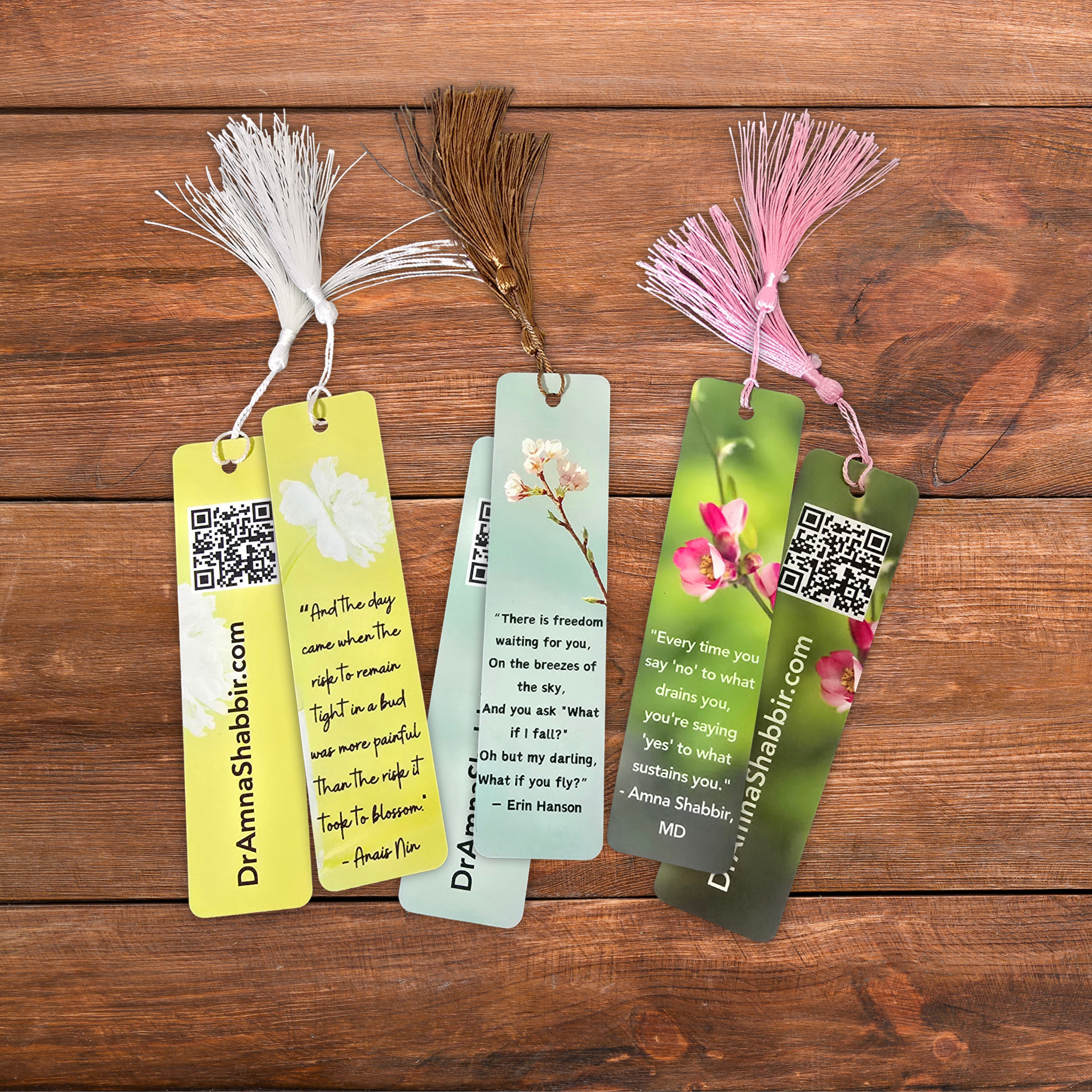 Set of colorful bookmarks with tassels on a wooden surface