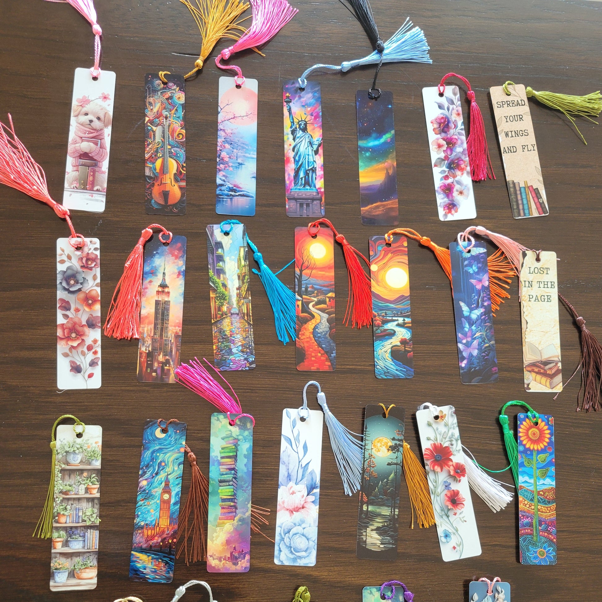 Various colorful bookmarks with tassels on a wooden surface