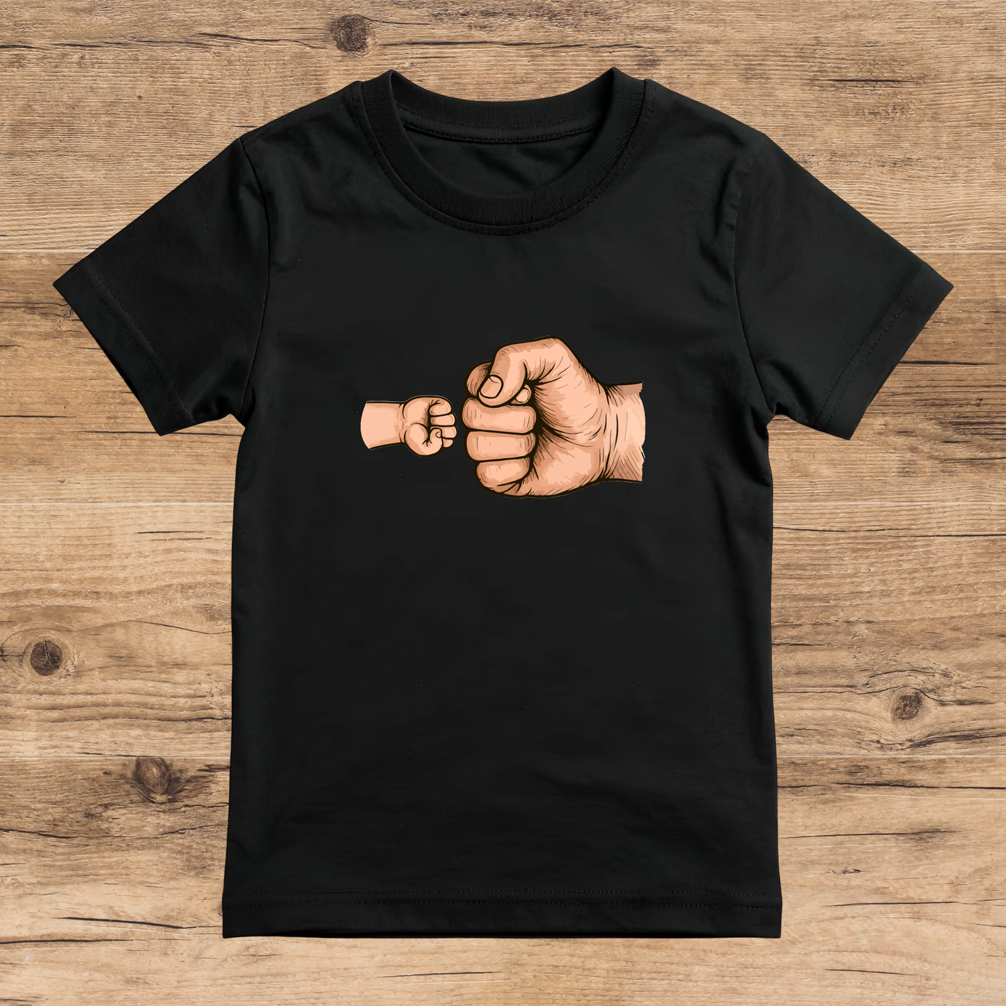 Black t-shirt with a graphic of two fists on a wooden surface