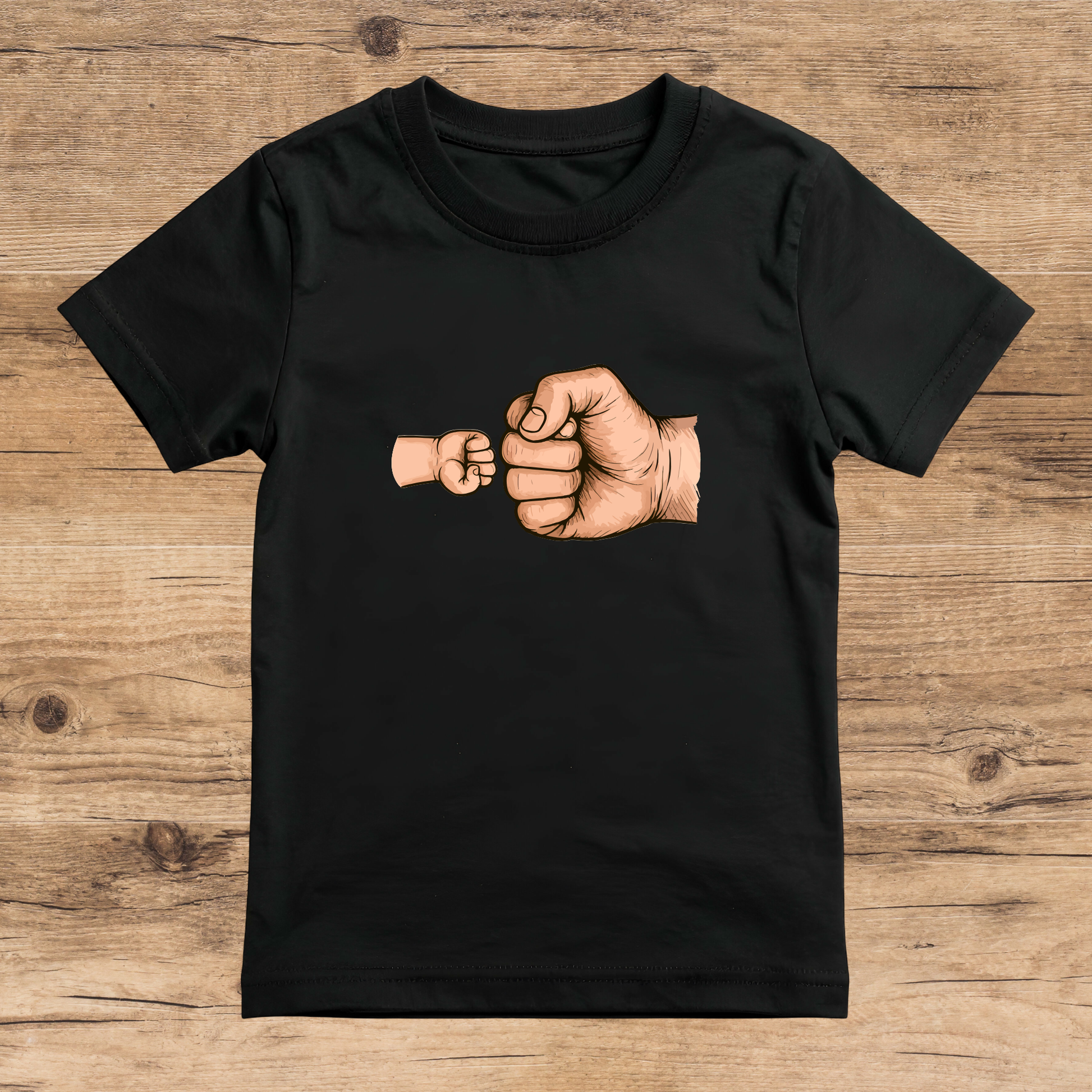 Black t-shirt with a graphic of two fists on a wooden surface