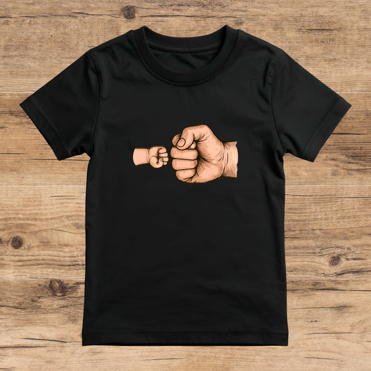 Black t-shirt with a graphic of two fists on a wooden surface