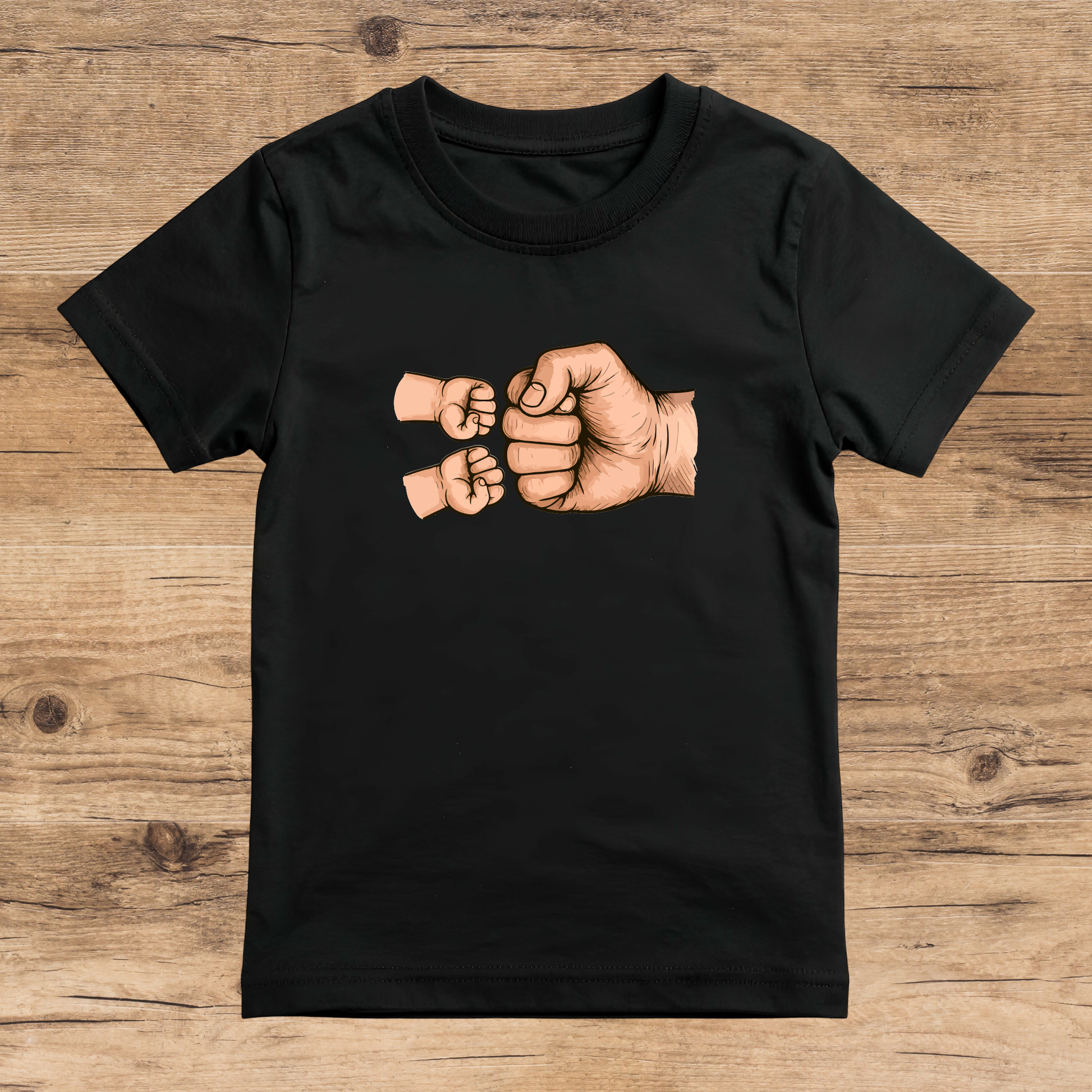 Black t-shirt with a graphic of two fists on a wooden surface