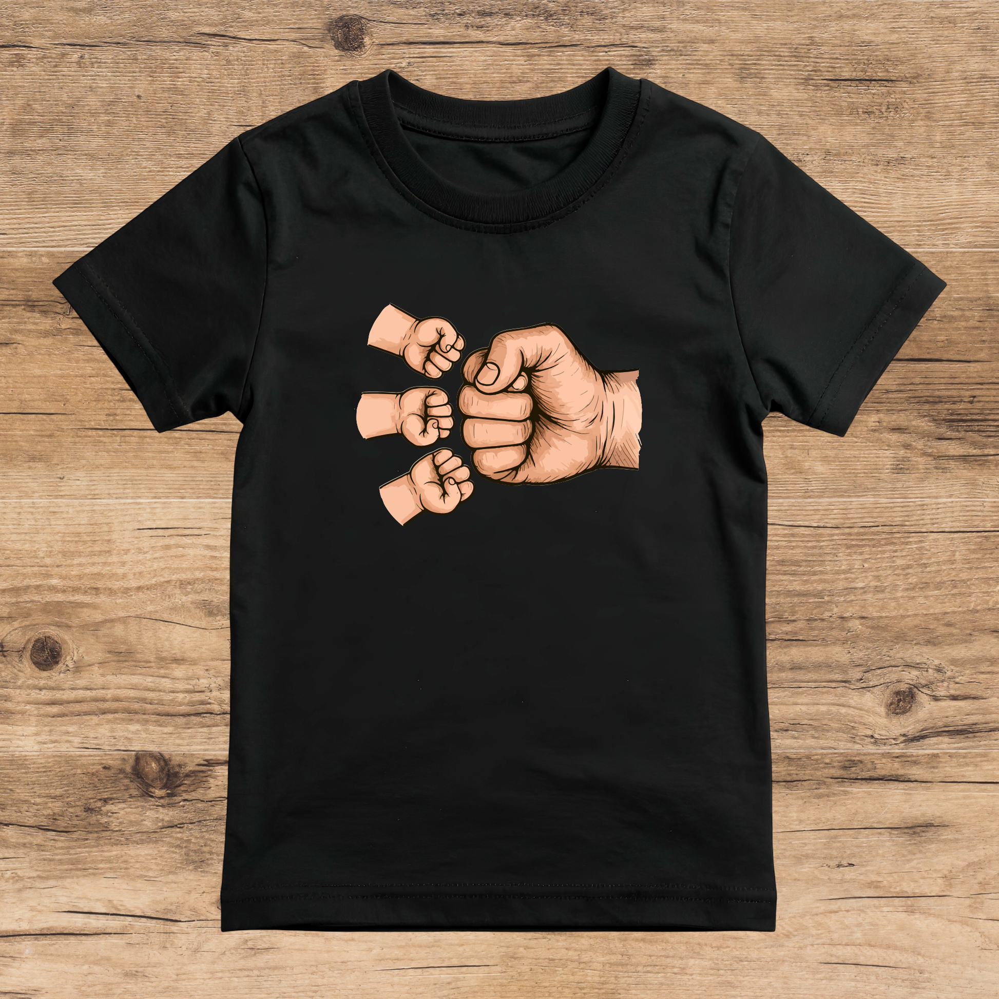Black t-shirt with graphic of three fists on a wooden surface
