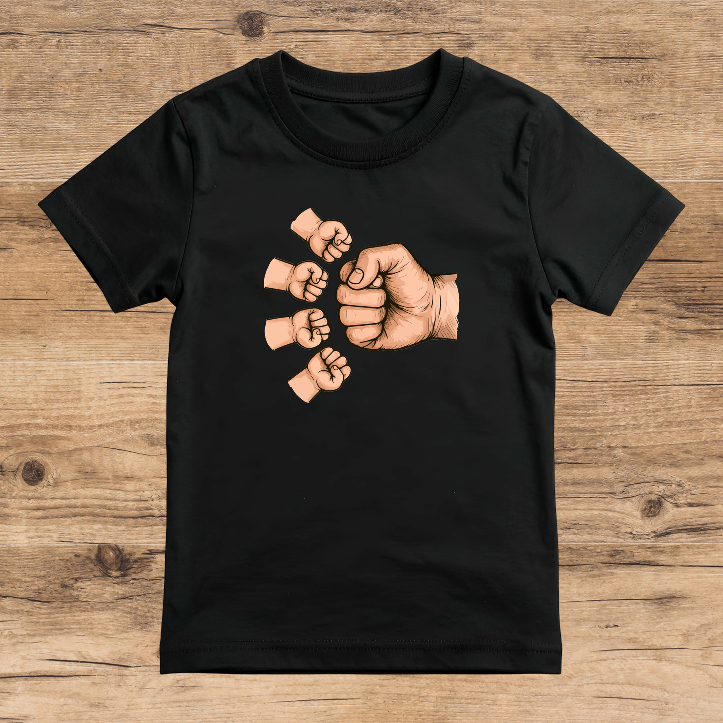 Black t-shirt with graphic of raised fists on a wooden surface