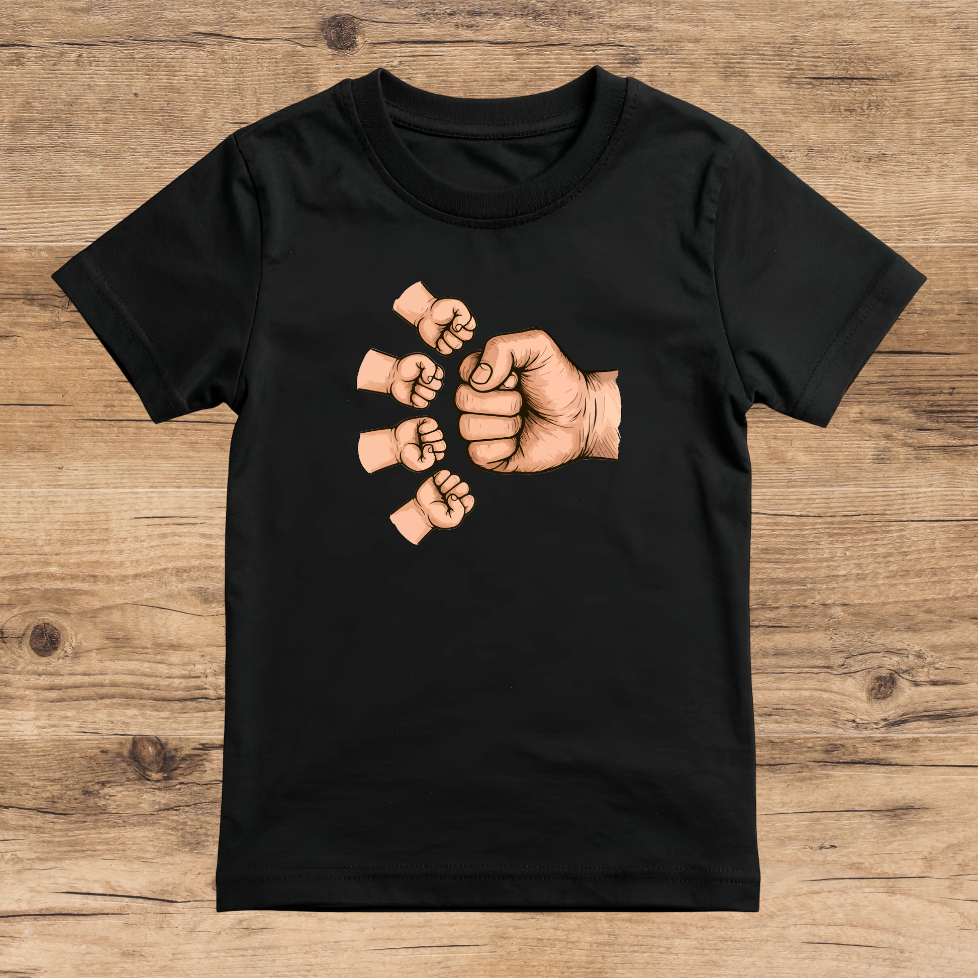 Black t-shirt with graphic of raised fists on a wooden surface