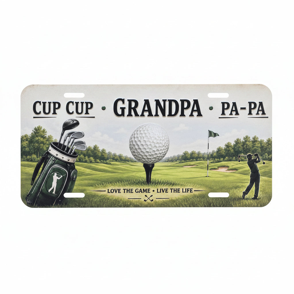 A novelty license plate featuring a golf course scene with a golf bag, golf ball, and golfer, with the text 'CUP CUP • GRANDPA • PA-PA' and 'LOVE THE GAME • LIVE THE LIFE'.
