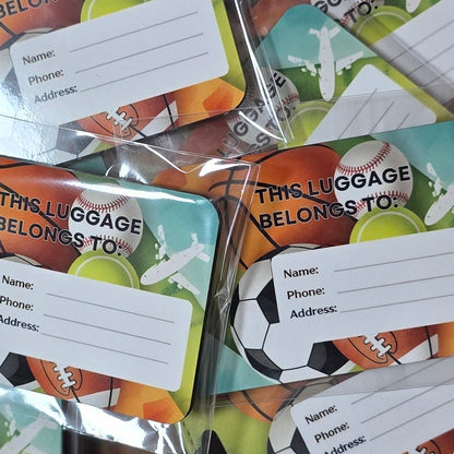 Multiple packages of sports-themed name tags on a wooden surface