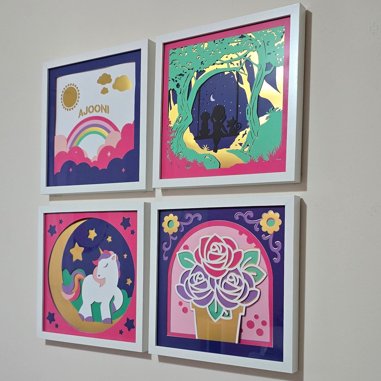Four colorful framed artworks on a wall