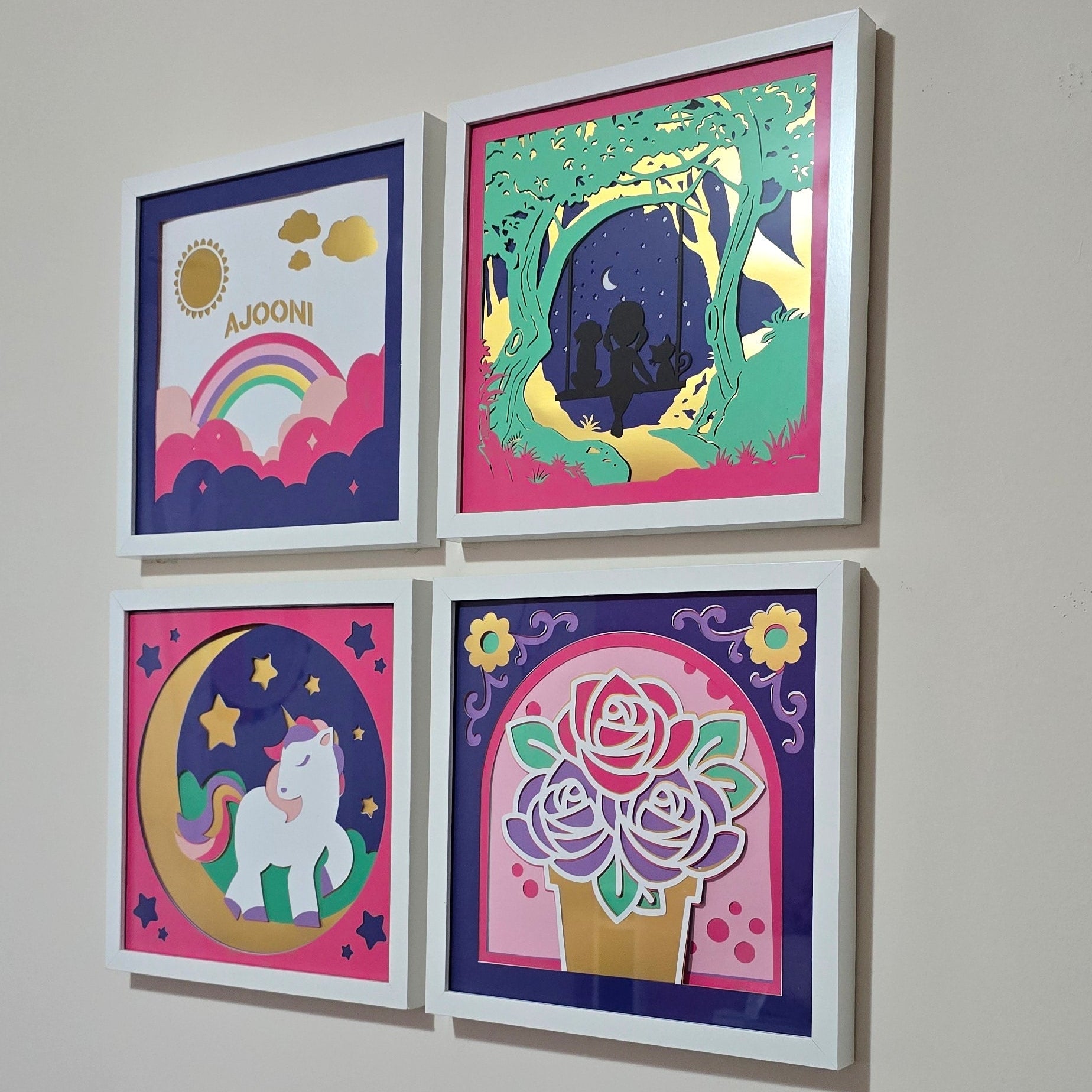 Four colorful framed artworks on a wall