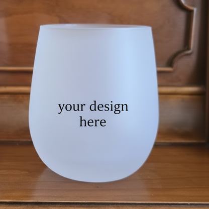 Frosted wine glass with 'your design here' text on a wooden surface